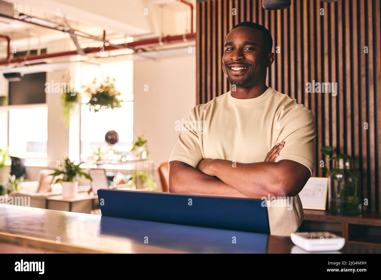 Portrait Of Small Business Owner In Shop Standing Behind Sales Desk Of Furniture Store Stock Photo