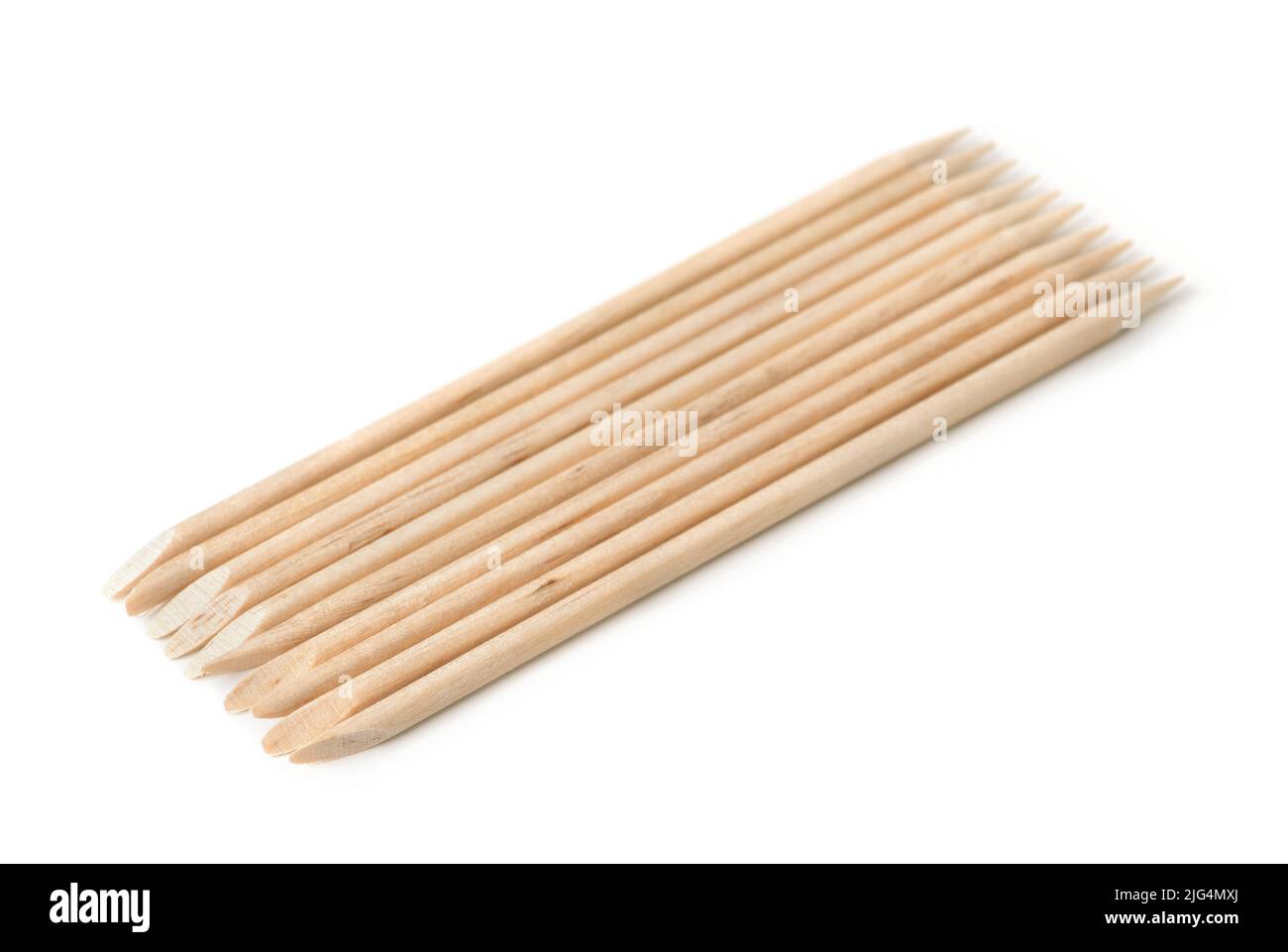 Group of orange wood sticks cuticle pushers isolated on white Stock Photo