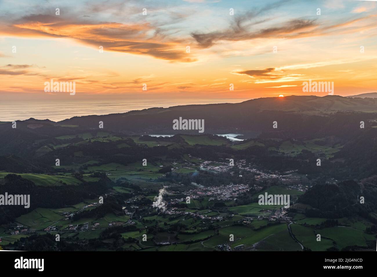 Panoramic view of the small village Furnas in the Sao Miguel island seen from the miradouro do Salto do Cavalo at the sunset. Azores, Portugal. Stock Photo