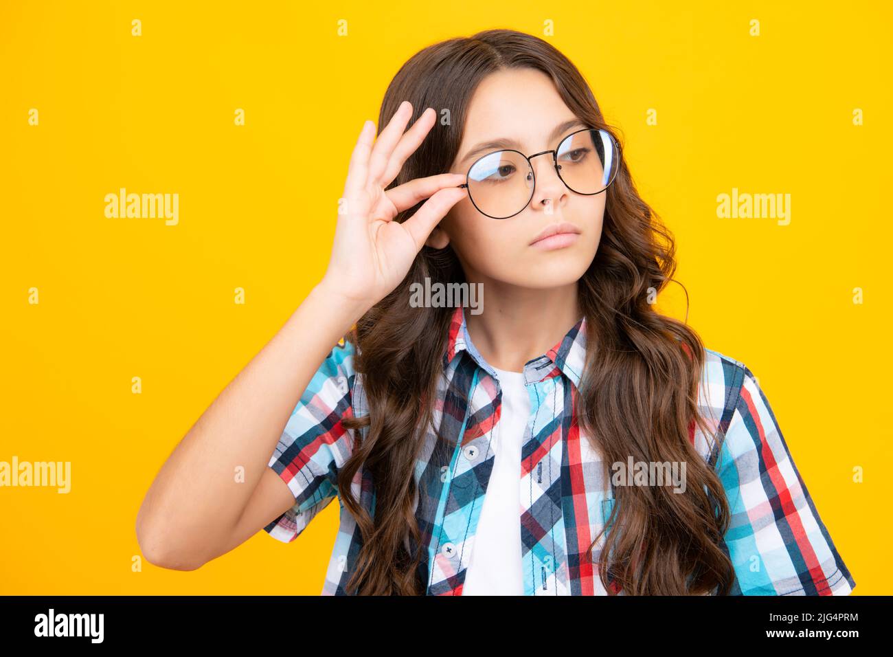 Teenager child with poor eyesight wear eyeglasses, looking squinting