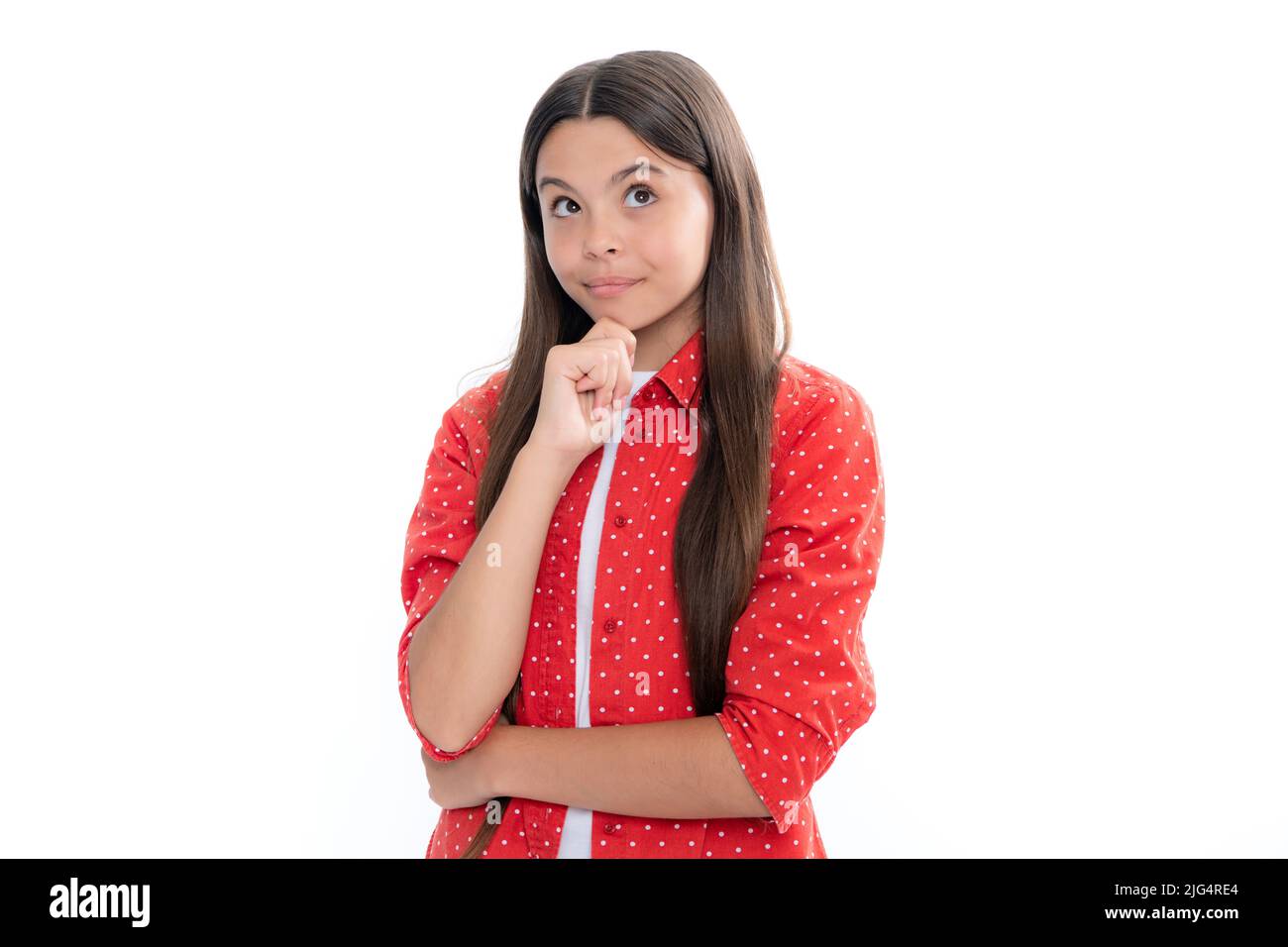 Teenager girl 12, 13, 14 years old thinking against white background. Child think and creative idea concept. Stock Photo