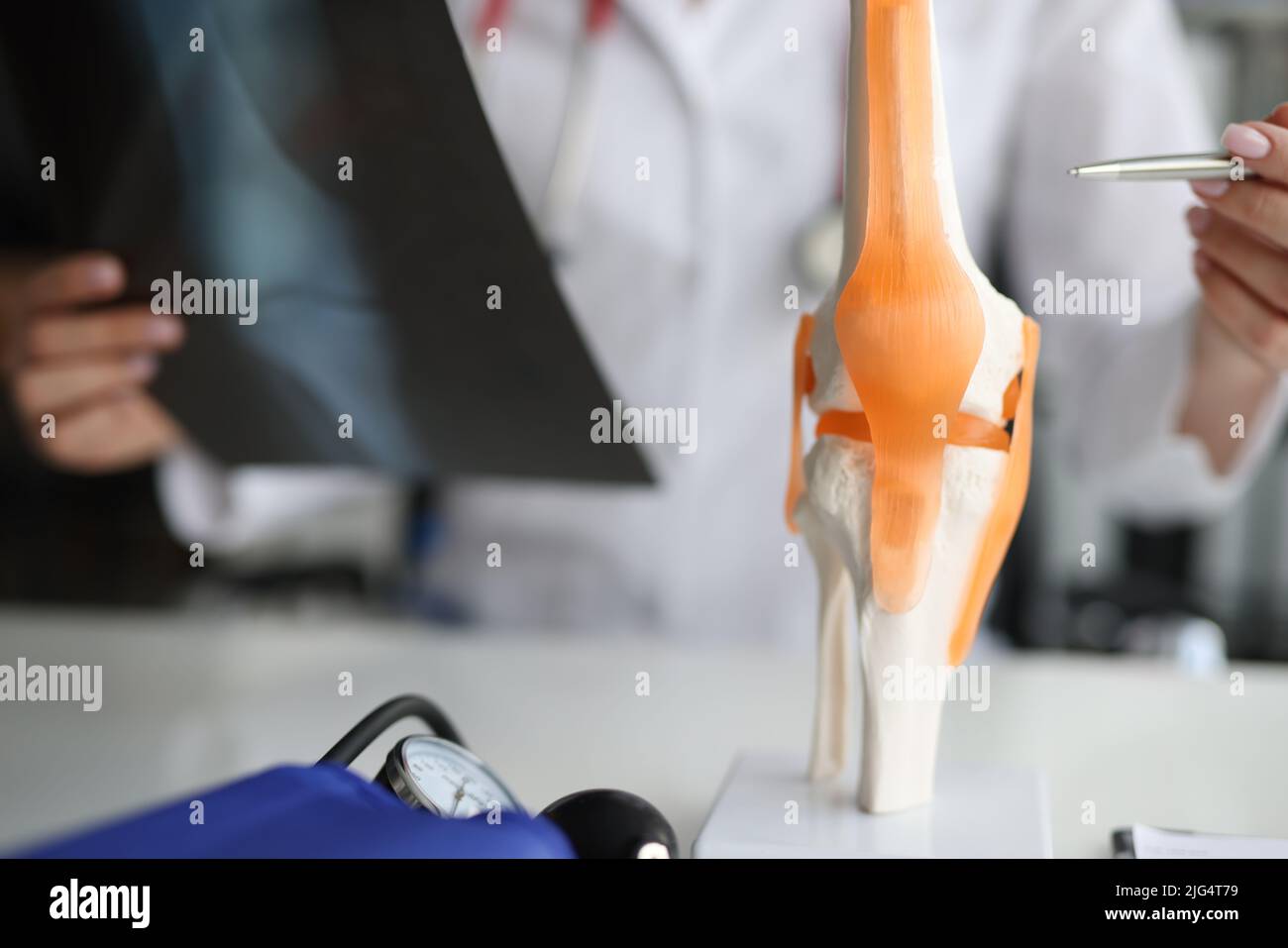 Doctor shows anatomy of knee joint and x-ray Stock Photo - Alamy