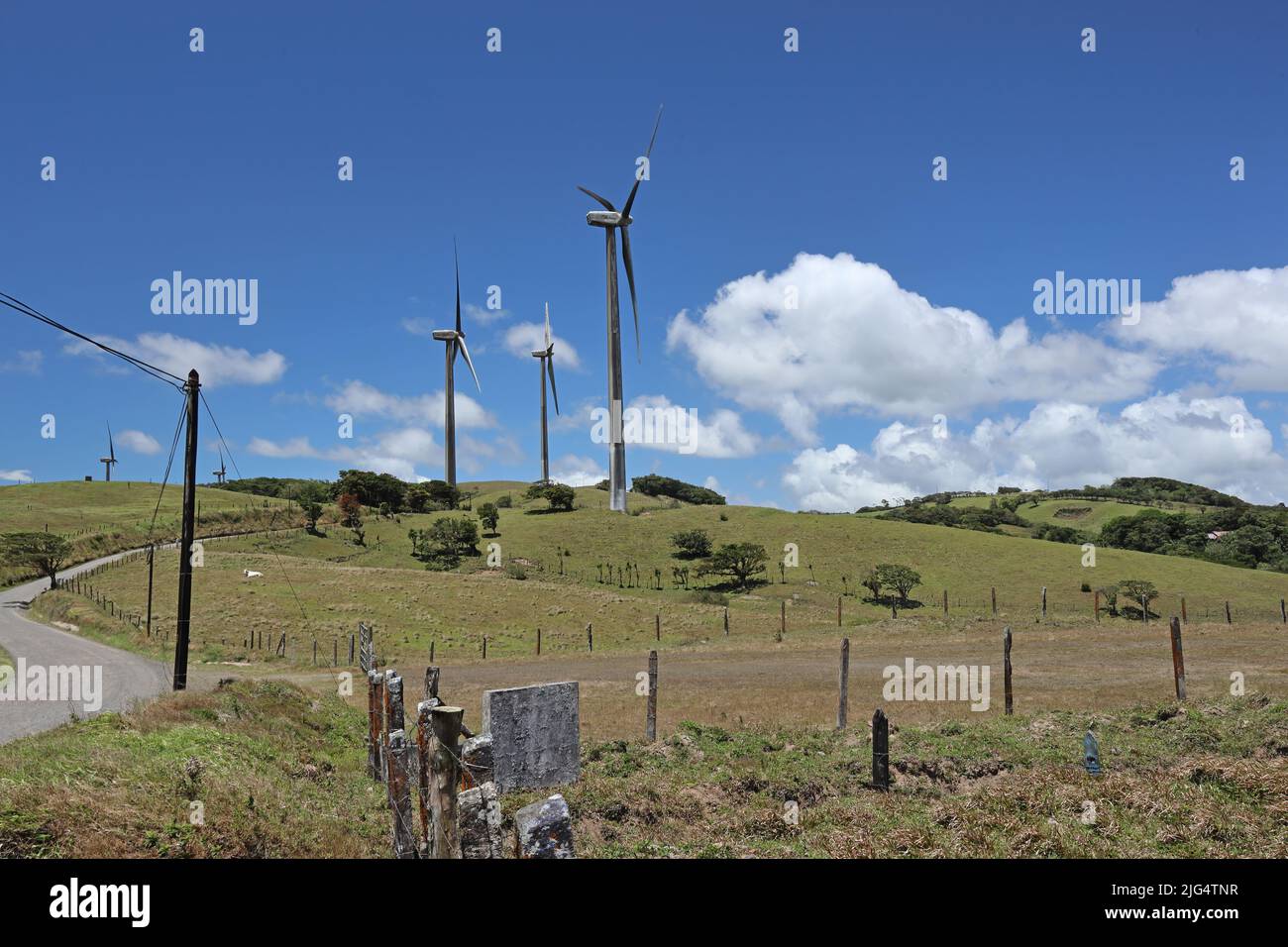 wind turbines on hill in farmland Costa Rica,               March Stock Photo