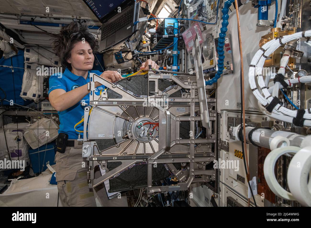 International Space Station Expedition 67 Flight Engineer Samantha Cristoforetti of the ESA, replaces centrifuge components inside the Columbus laboratory module BioLab, a research facility that studies the effects of space and radiation on single celled and multi-cellular organisms aboard the orbiting spacelab, June 23, 2022 in Earth Orbit. Stock Photo