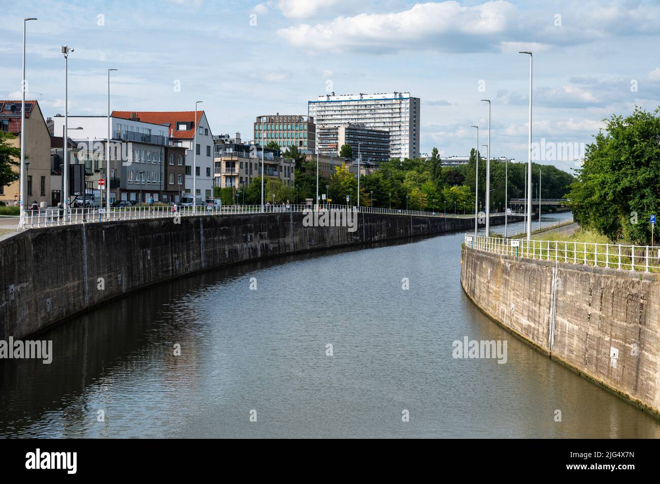 Anderlecht, Brussels Capital Region, Belgium, 07 02 2022 - Bridge view over the water and the suburban apartment blocks near the sluice Stock Photo