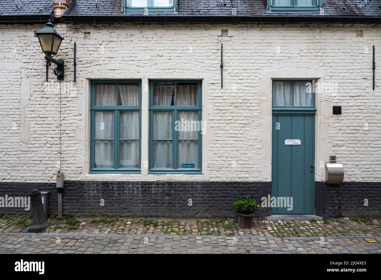 Leuven, Flemish Brabant Region, Belgium - 07 01 2022 - Facade of historical brick stone houses with bikes Stock Photo