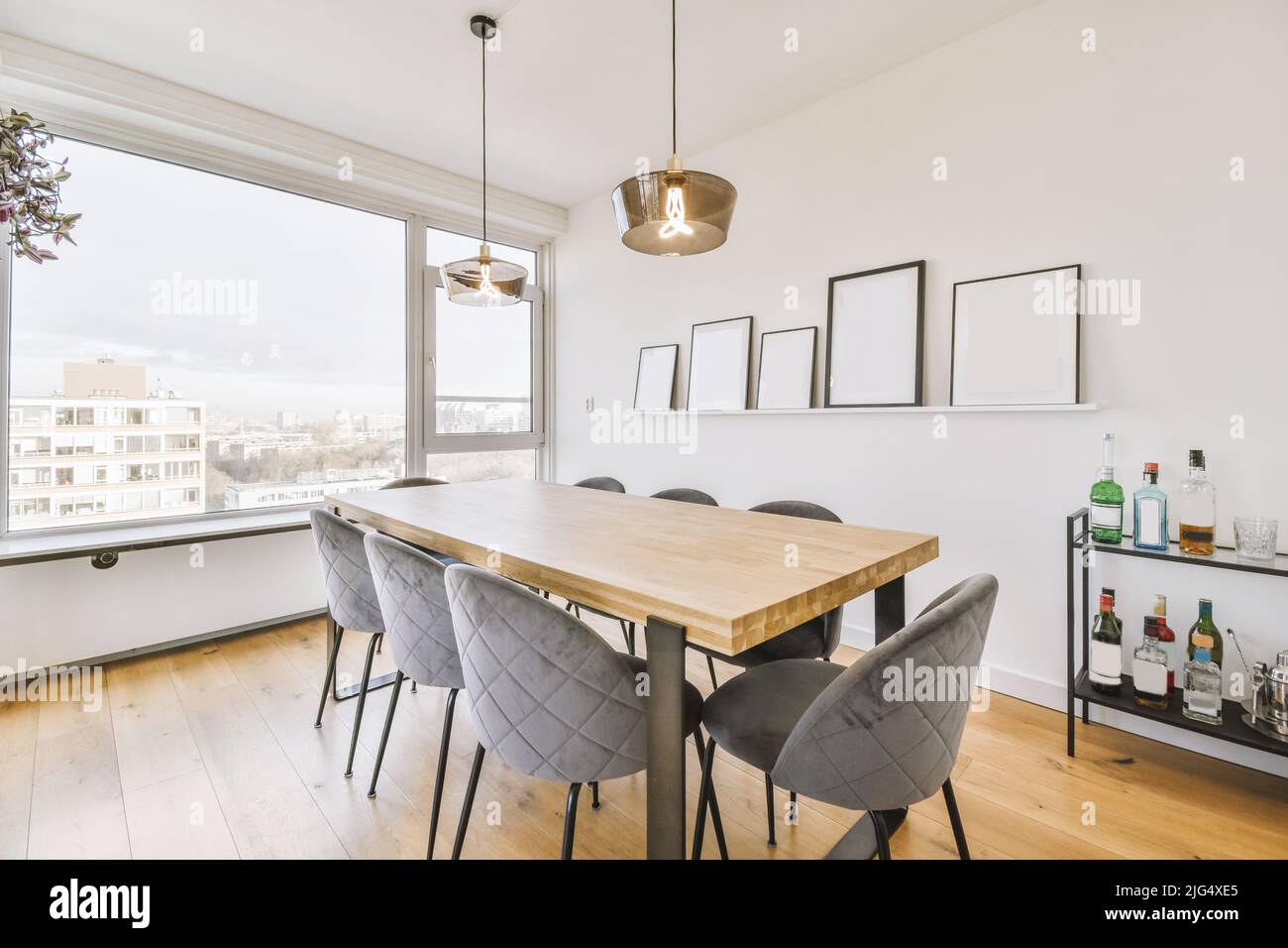 Table and chairs under the lamps in the dining room with panoramic windows Stock Photo Alamy