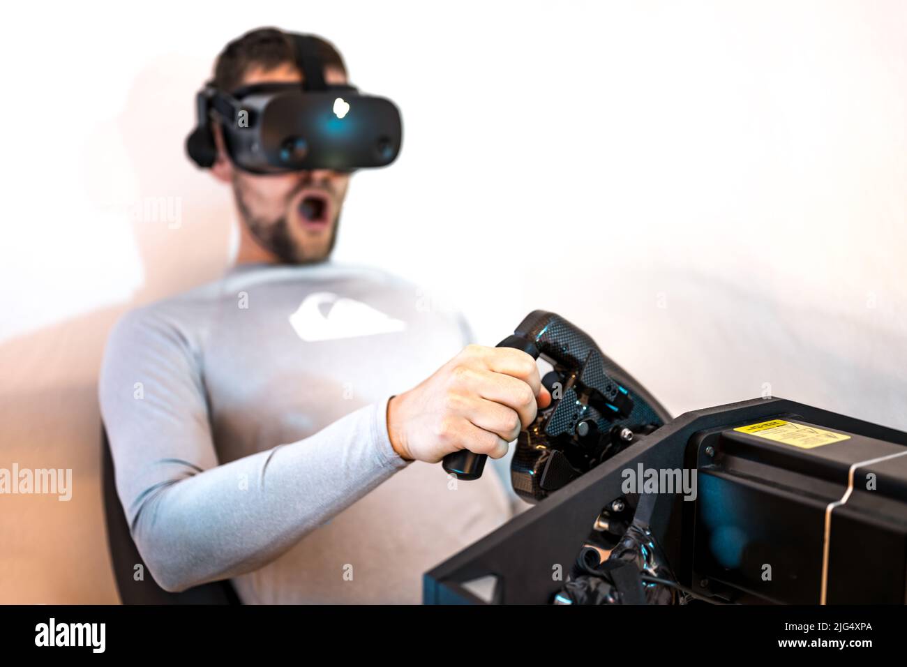 A gamer is having fun with a high end simracing rack Stock Photo