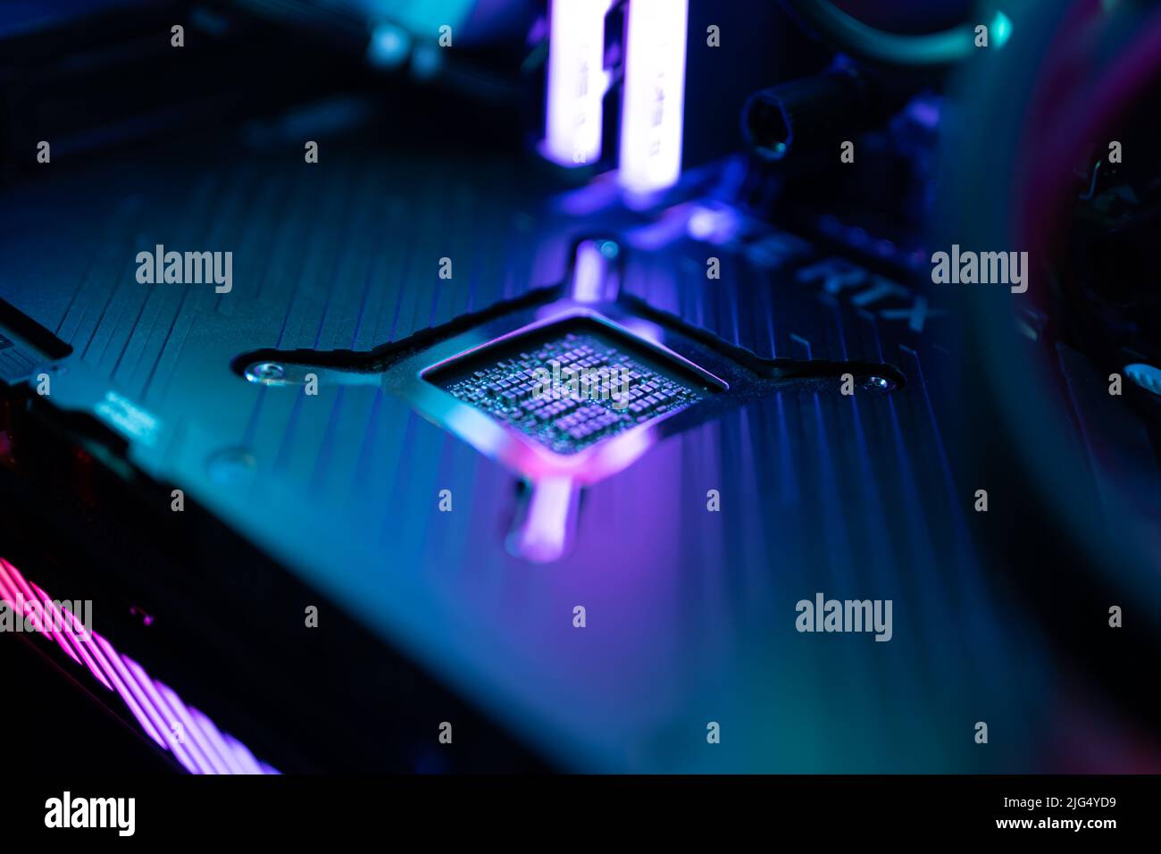 A high end gaming computer is illuminated with rainbow colors. All