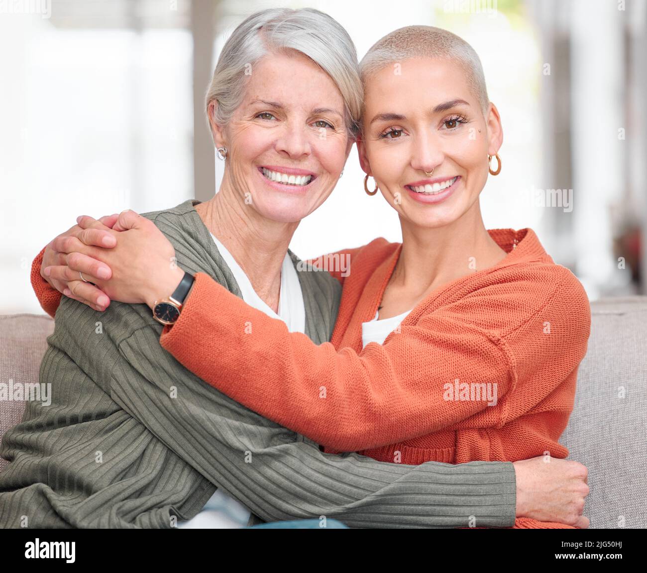 She is my rock. Cropped portrait of an attractive young woman and her senior mother sitting on the sofa at home. Stock Photo
