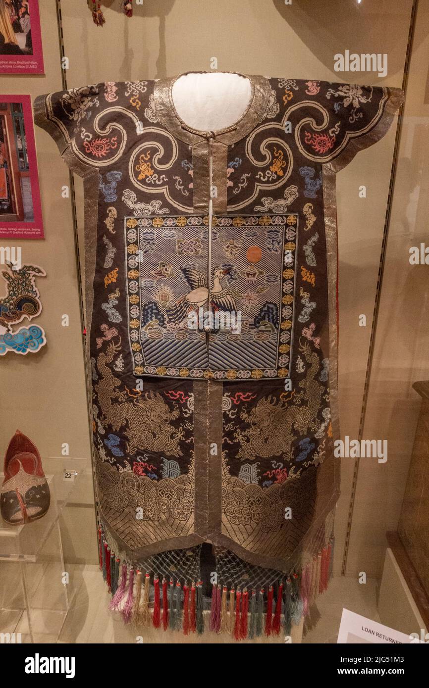 A tabard with rank badge from China (c.1900) worn by government officials in the Qing dynasty on display in the UK. Stock Photo