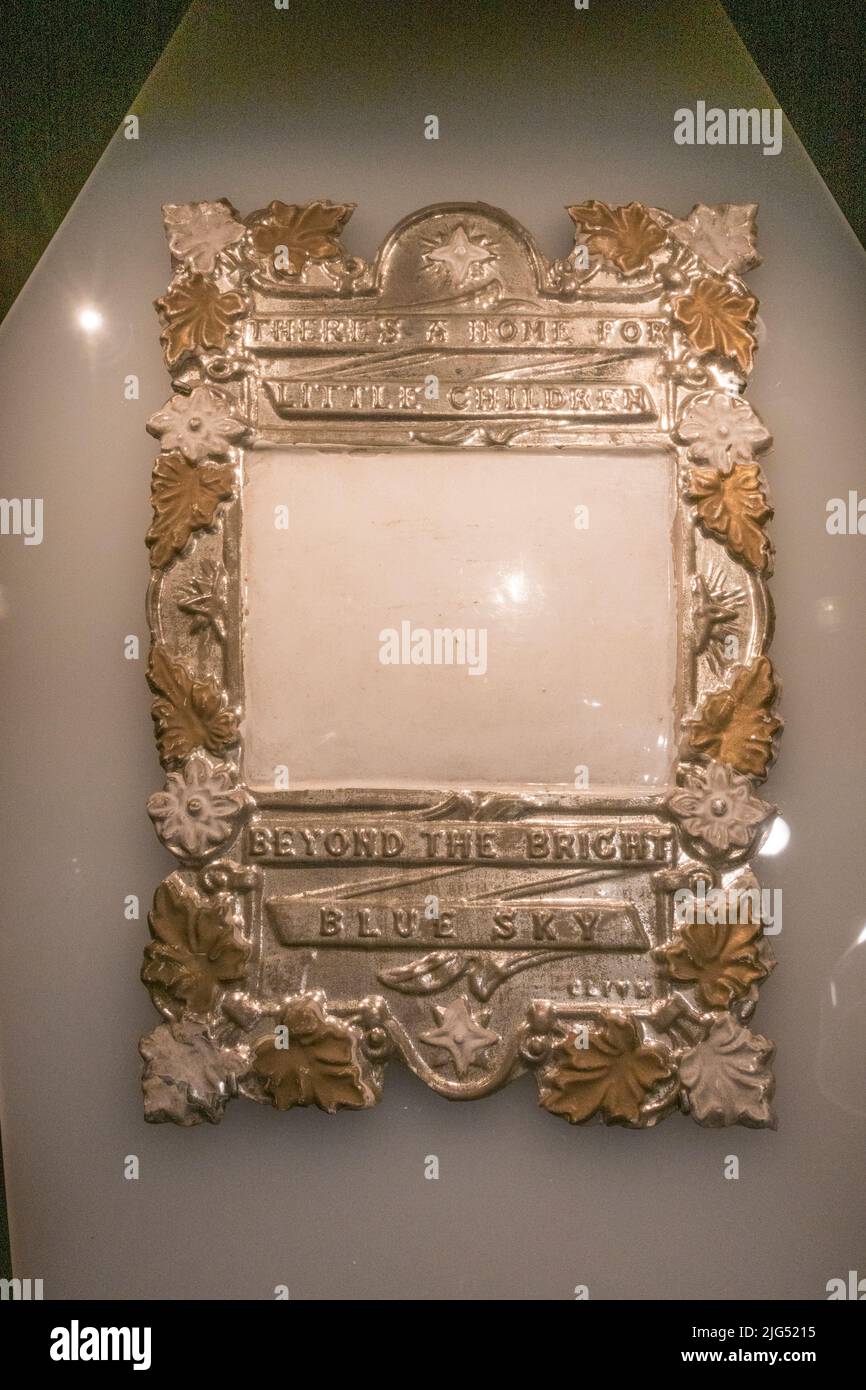 A coffin plate (c1850-1870) made of tin for a childs coffin (the name would be engraved in the blank panel) on display in the UK. Stock Photo