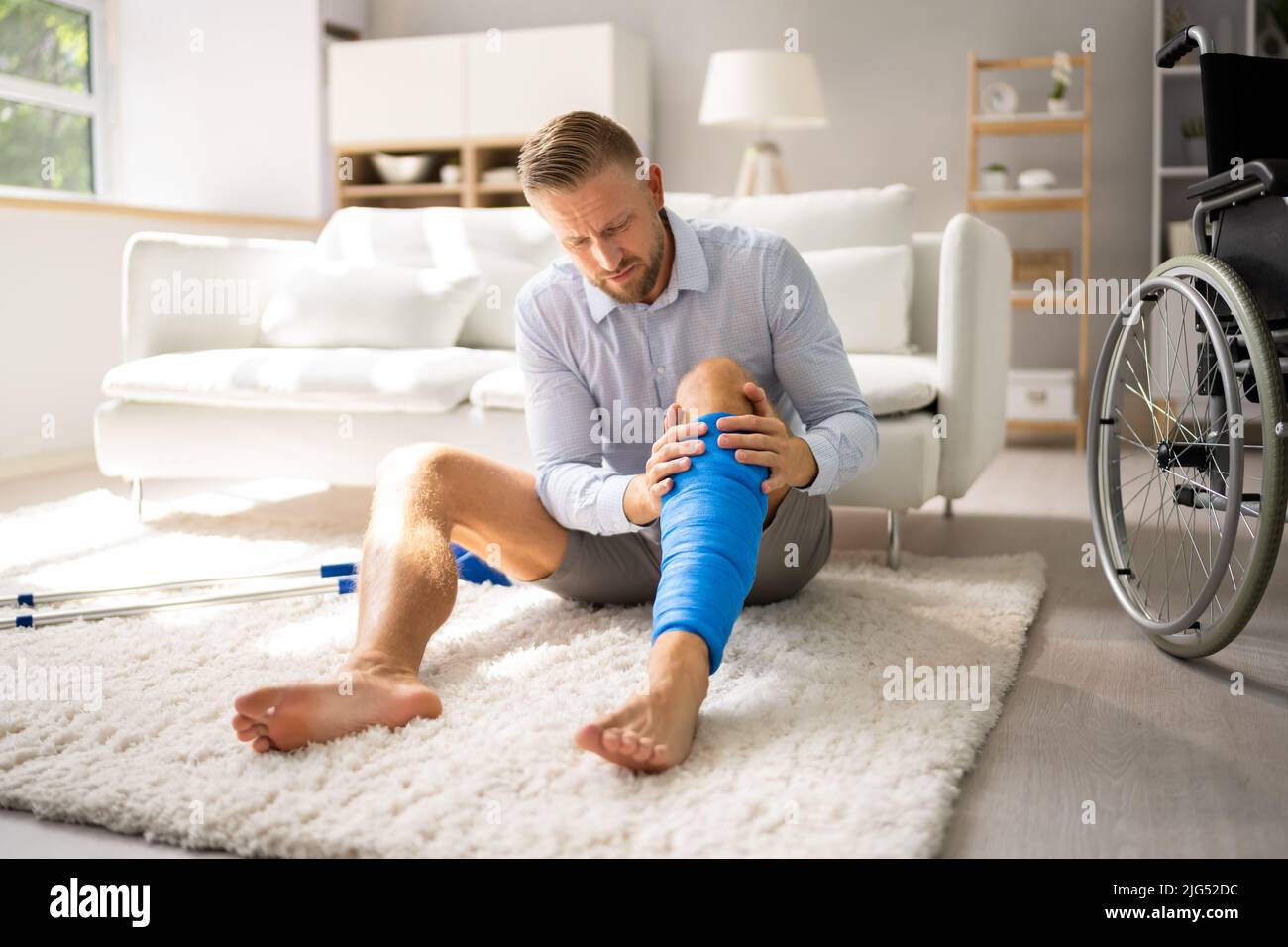 Man With Broken Leg And Cast. Crutches And Wheelchair Stock Photo Alamy