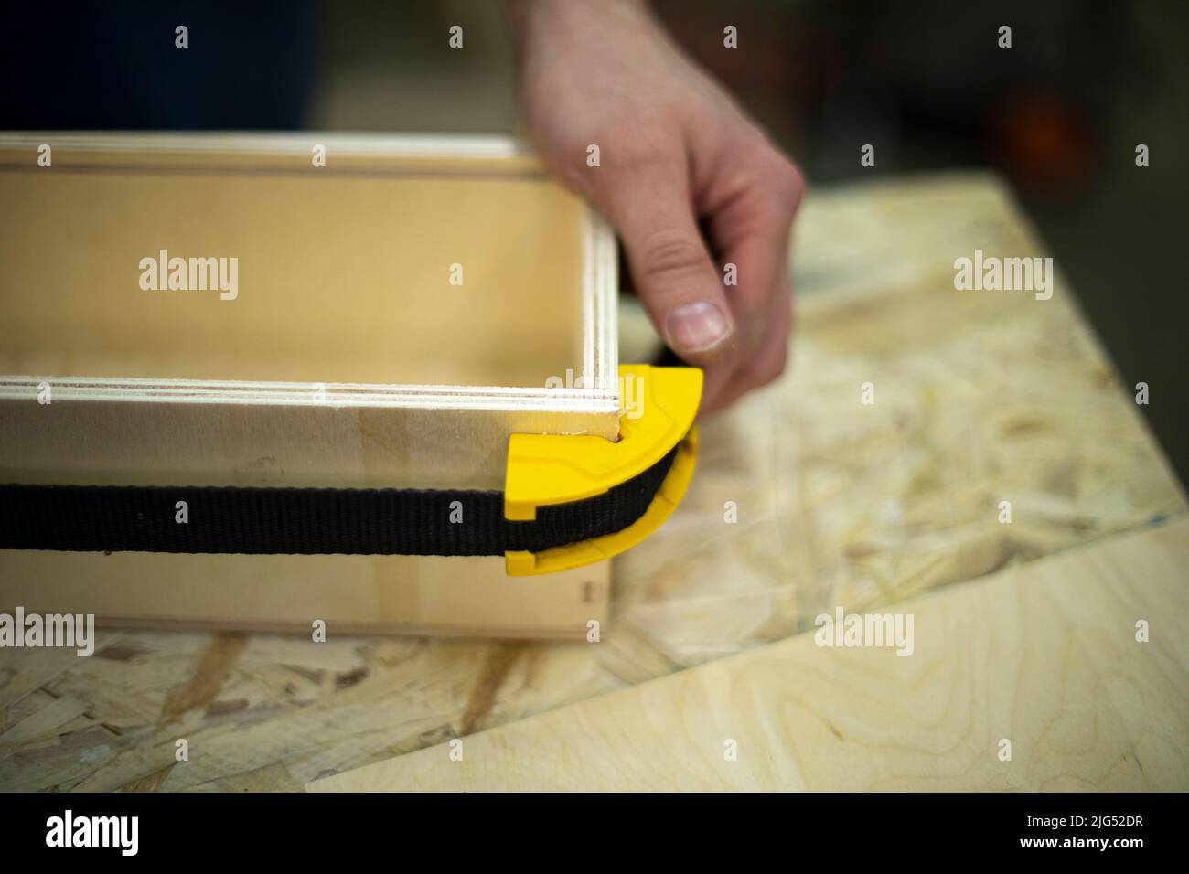 Hand holds box. Guy creates box out of wood. Work in workshop. Wood ...