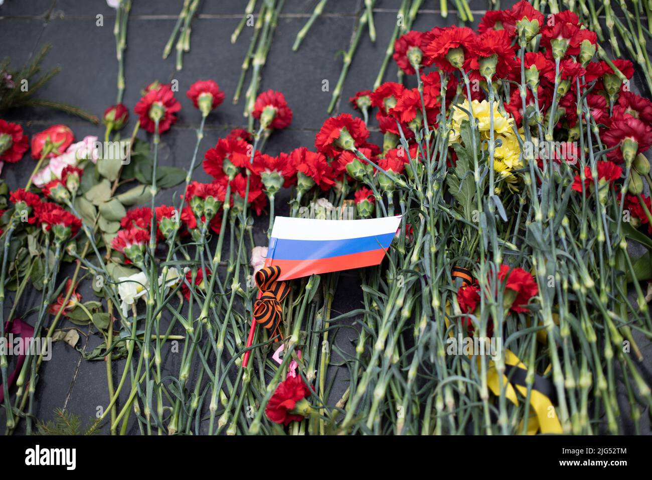 Flowers on grave of soldier in Russia. Details of funeral ceremony at
