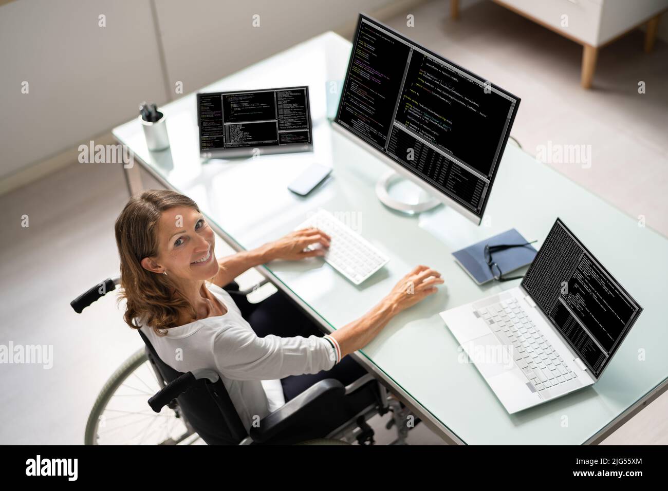 Programmer Woman Coding On Multiple Computer Screens Stock Photo - Alamy