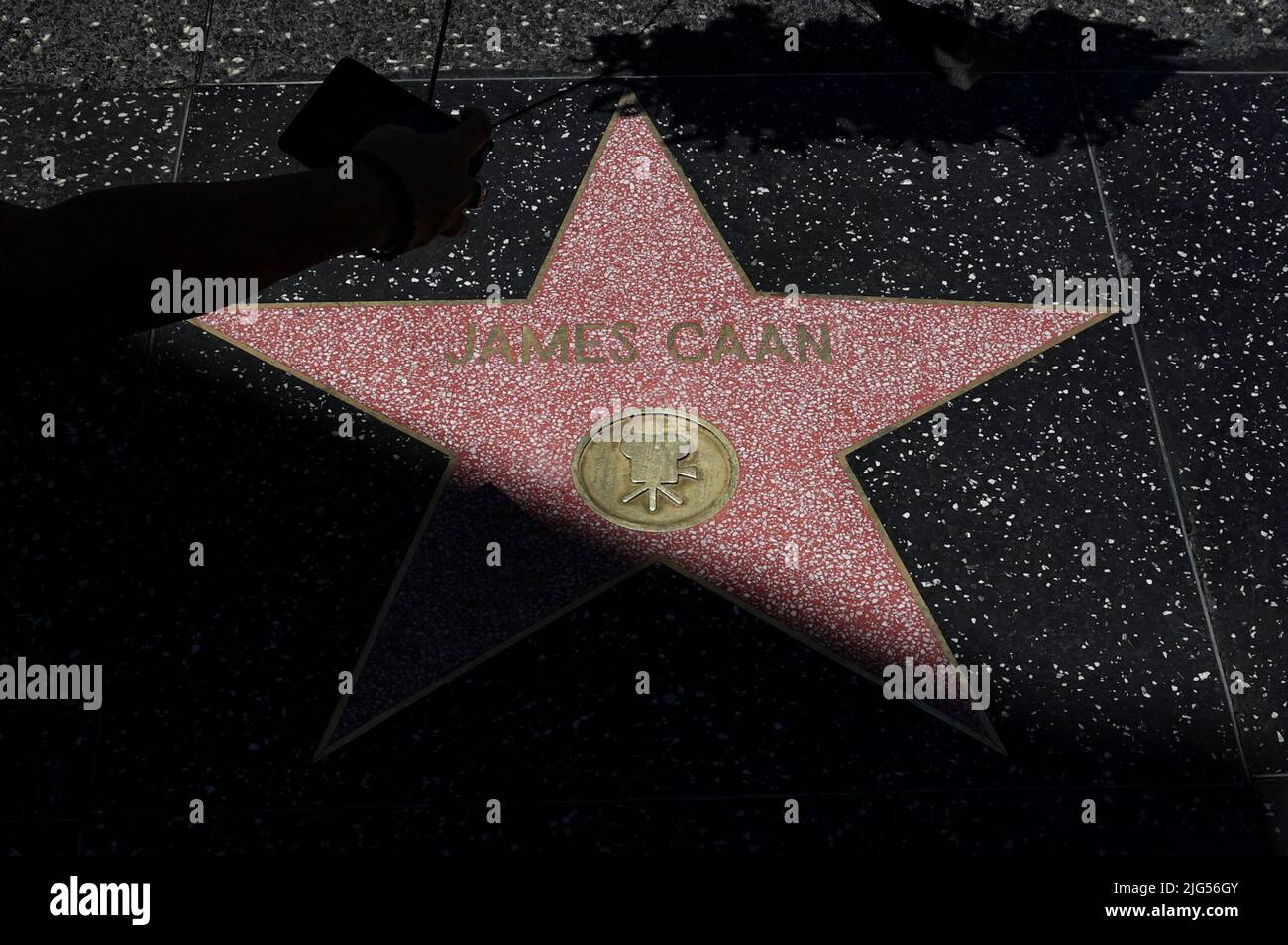 A woman uses her mobile phone  to make images of late actor James Caan's star on the Hollywood Walk of Fame, Los Angeles, California, U.S., July 7, 2022 REUTERS/Mario Anzuoni Stock Photo