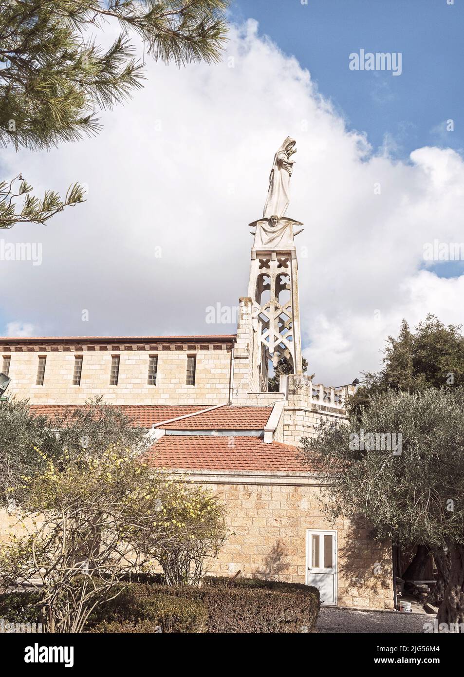 statue of Mary and Jesus sits atop the historic Catholic church and Ark of the Coventant monastery in Abu Gosh near Jerusalem in Israel Stock Photo