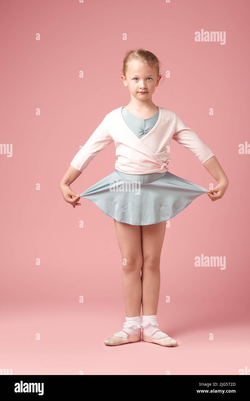 Cute Ballerina on Pink. Shot of cute little girl in her leotard against a studio background. Stock Photo