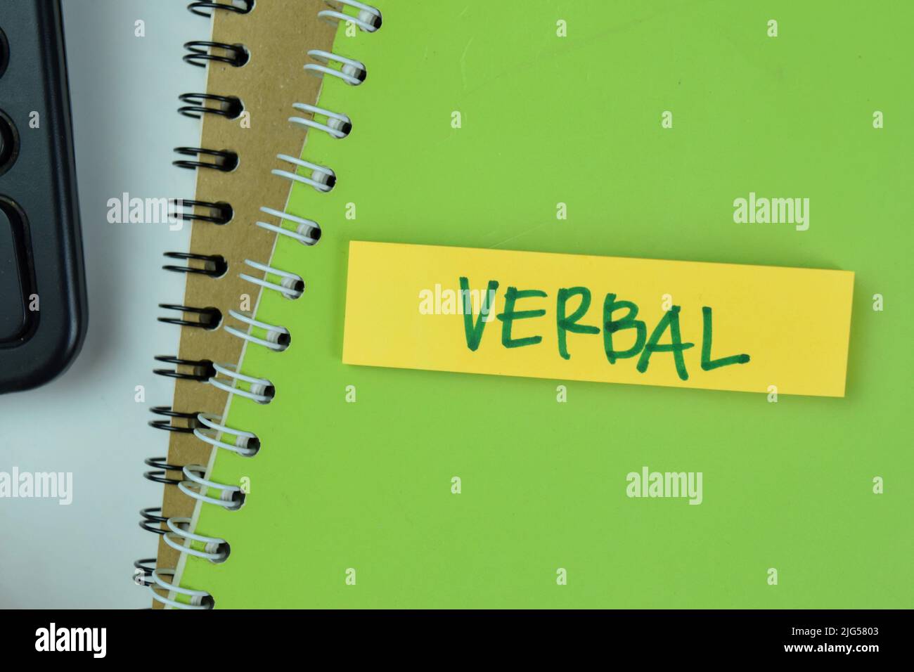 Concept of Verbal write on sticky notes isolated on Wooden Table. Stock Photo