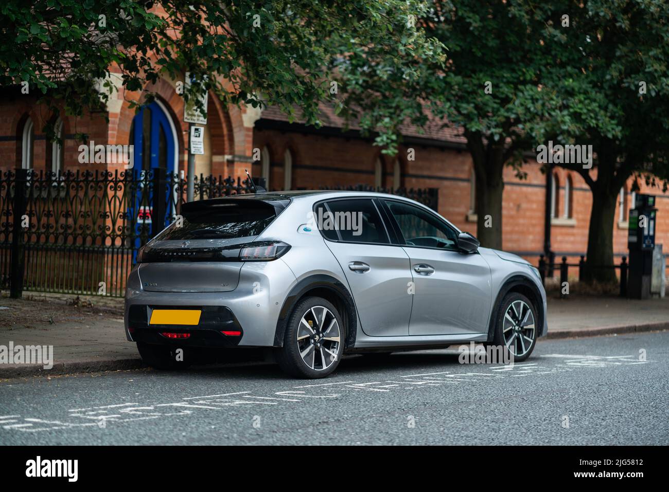 Peugeot e208 GT Electric Vehicle at Charging Point Stock Photo