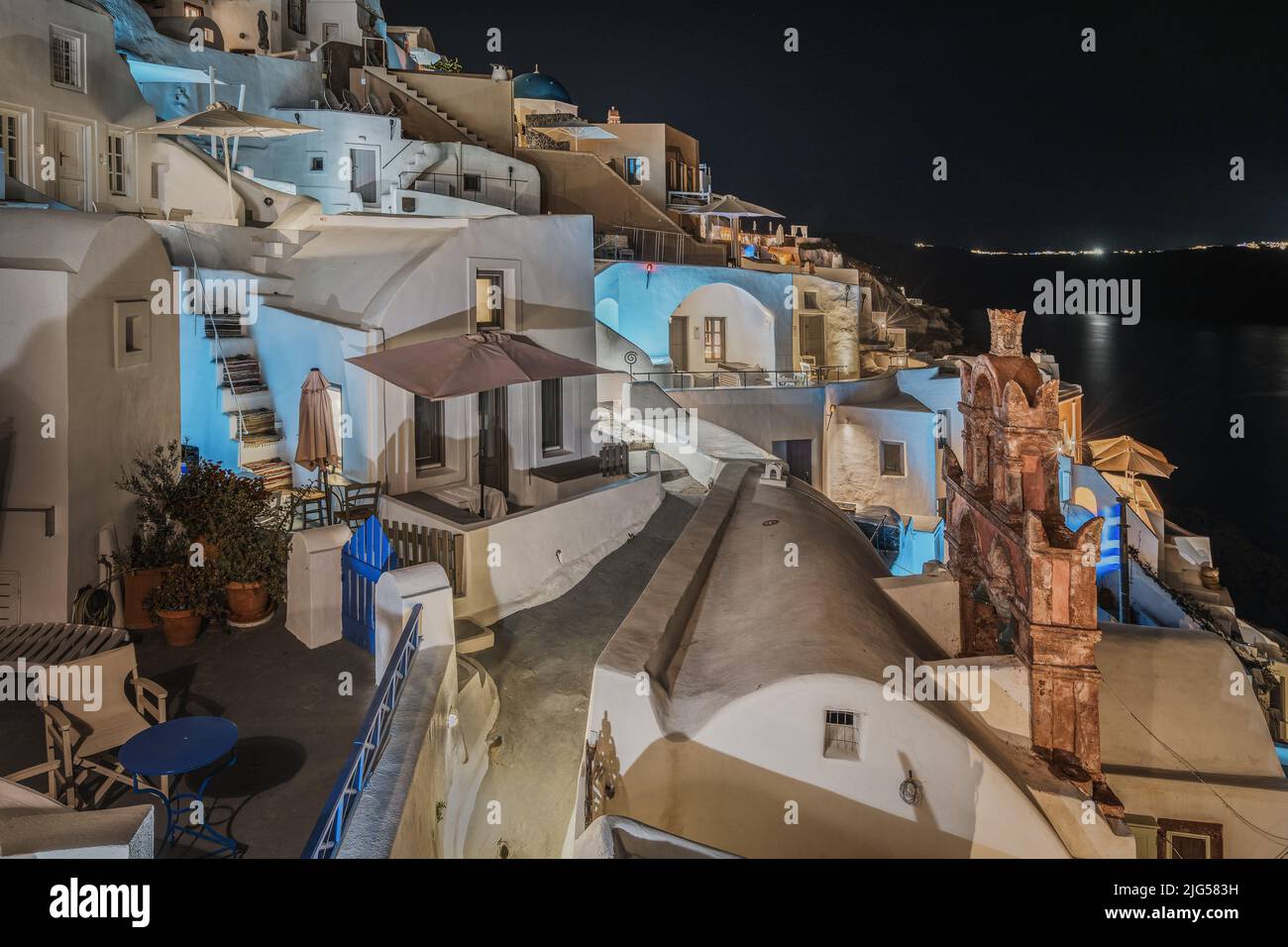 View of Oia village at night with typical whitewashed houses illuminated, Santorini, Greece Stock Photo