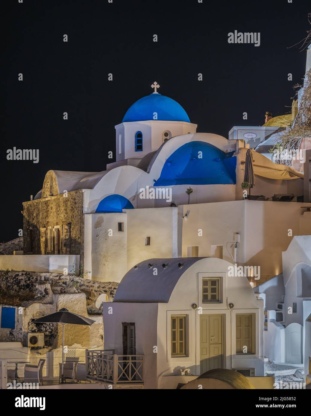Typical church in Oia village (Santorini) with blue dome at night, Greece Stock Photo
