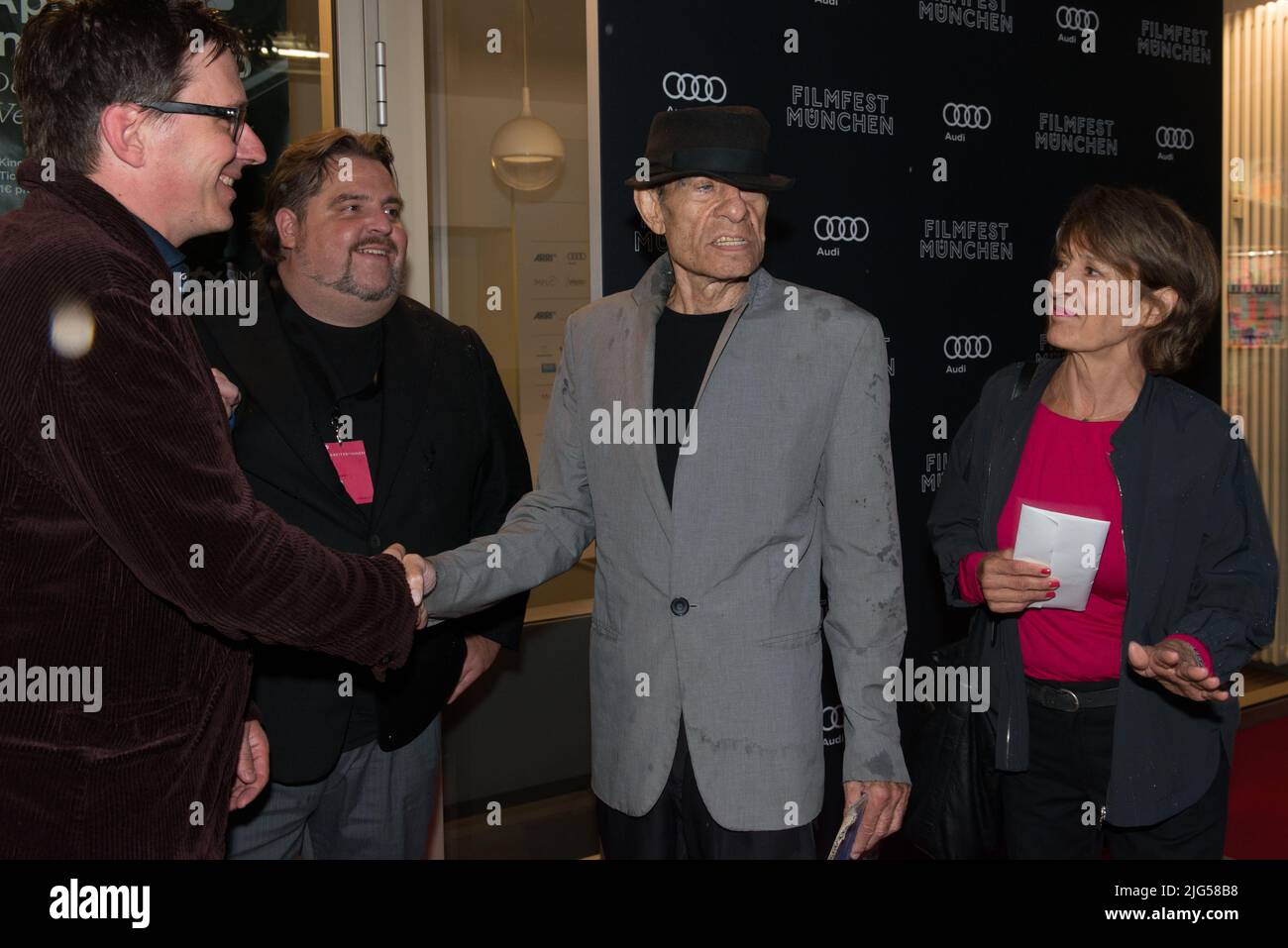 Munich, Germany, July 7, 2022, Director Klaus Lemke seen before the screening of his Film CHAMPAGNER FÜR DIE AUGEN - GIFT FÜR DEN REST at City Cinema during  39. Filmfest München with Urs Spörri, Florian Kummert and his wife. He died at the age of 81 years on July 7, 2022 in Munich Stock Photo