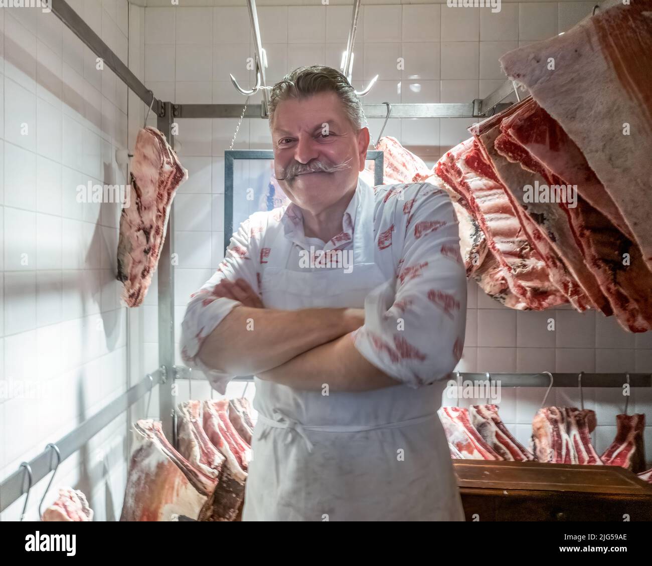 Panzano in Chianti, Italy, 7 July 2022.  Italian butcher and chef Dario Cecchini poses inside a meat refrigerator in his butcher shop Antica Macelleri Stock Photo