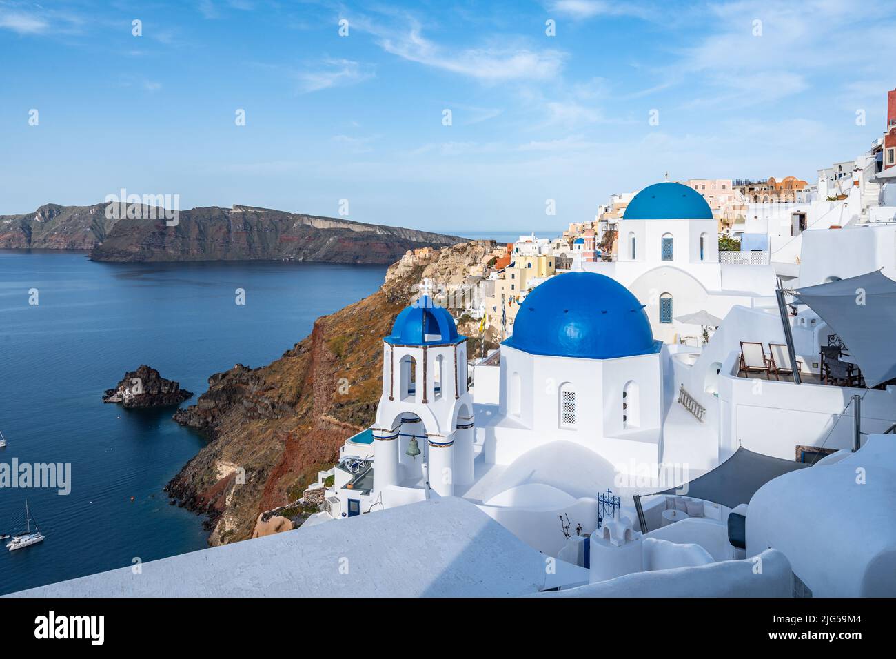 View of Oia in Santorini, the most famous village of the island with the typical white houses and blue domed churches Stock Photo
