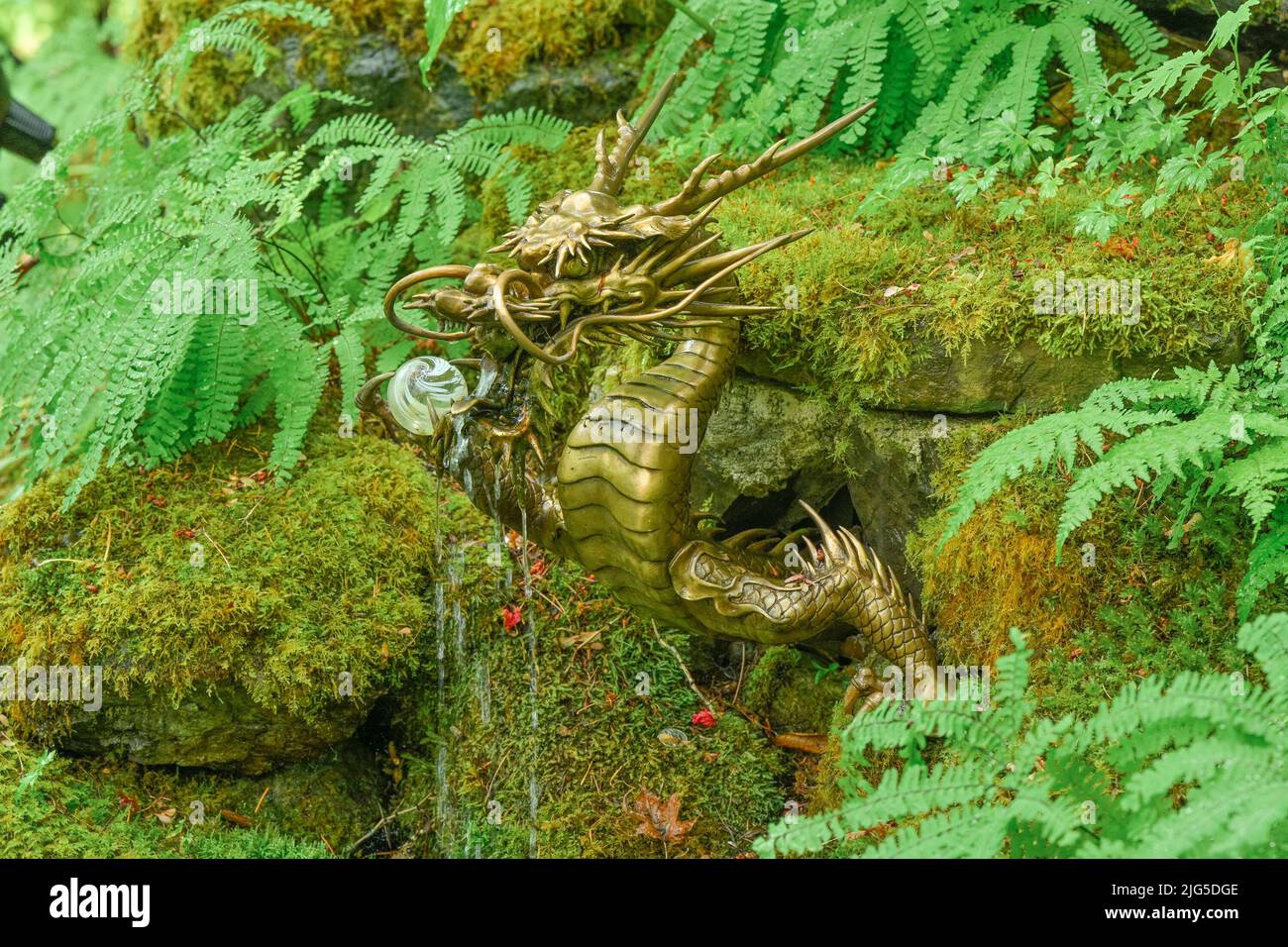 Metal dragon sculpture in lair, Japanese Garden, Butchart Gardens, Brentwood Bay, Greater