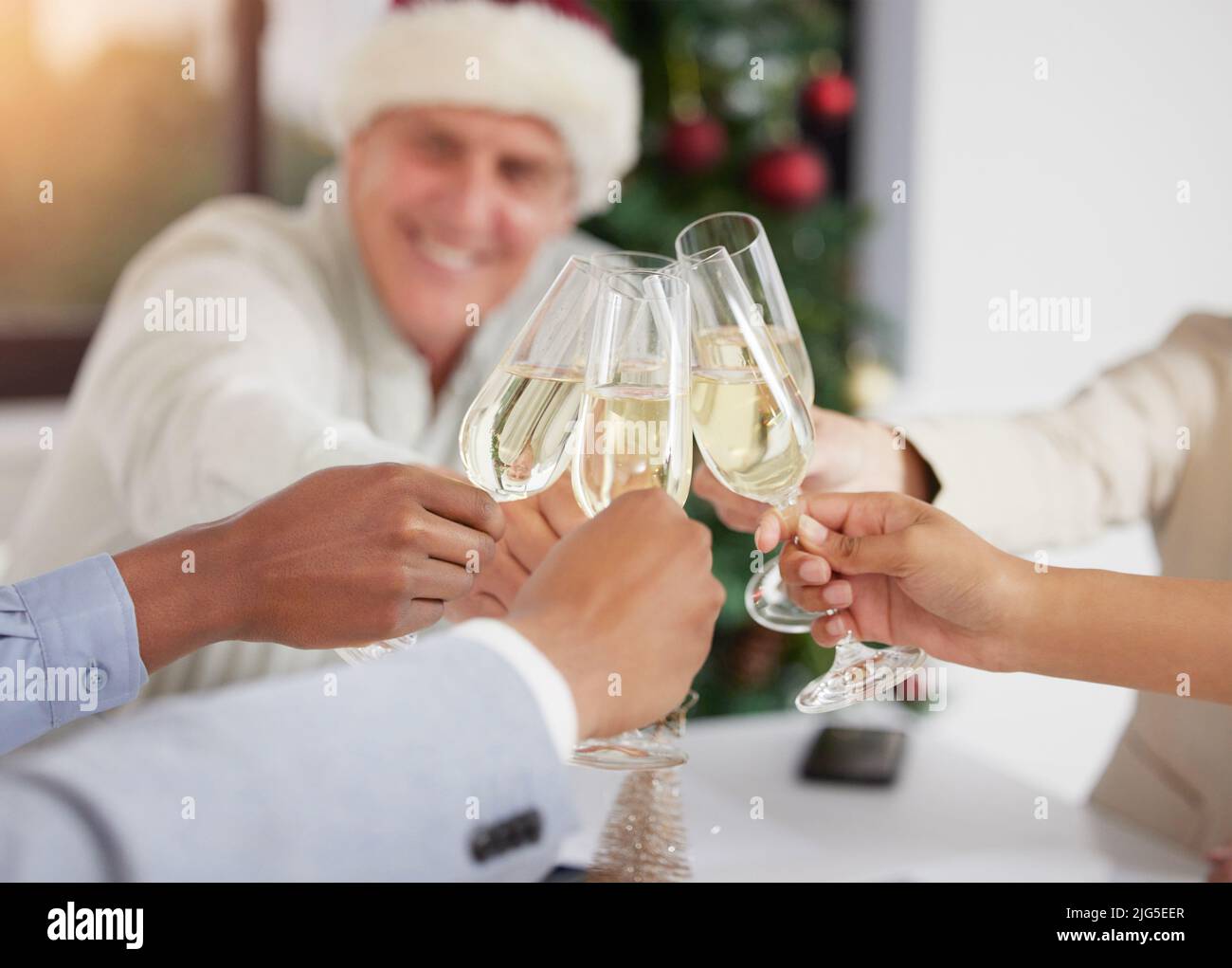 Lets toast to success. Shot of a group of unrecognizable businesspeople