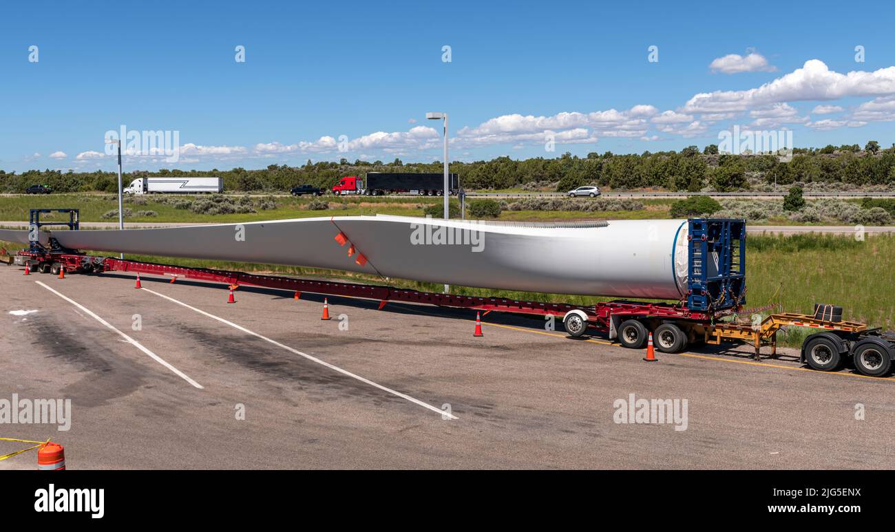 Single long wind turbine blade on a truck resting at a rest area in Idaho state. Stock Photo