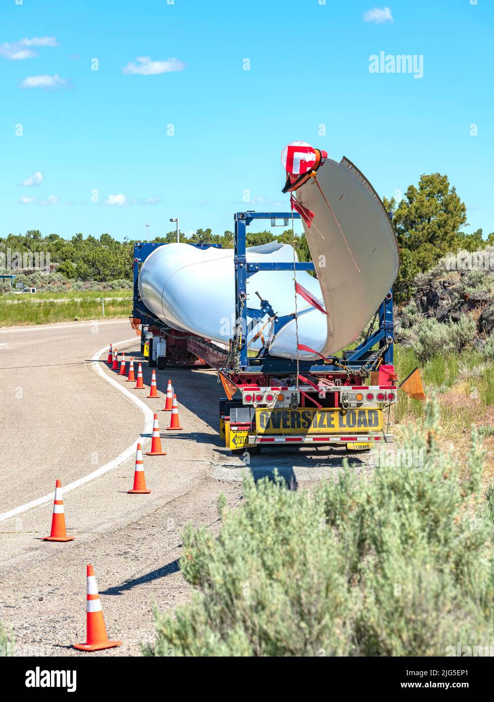 Single long wind turbine blade on a truck resting at a rest area in Idaho state. Stock Photo