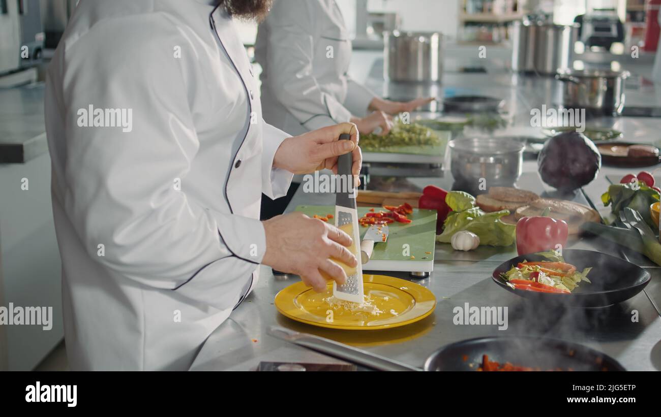 https://c8.alamy.com/comp/2JG5ETP/male-chef-grating-parmesan-cheese-on-kitchen-grater-to-cook-gastronomy-recipe-in-professional-cuisine-authentic-cook-preparing-shredded-cheddar-ingredient-to-make-gourmet-meal-dish-2JG5ETP.jpg