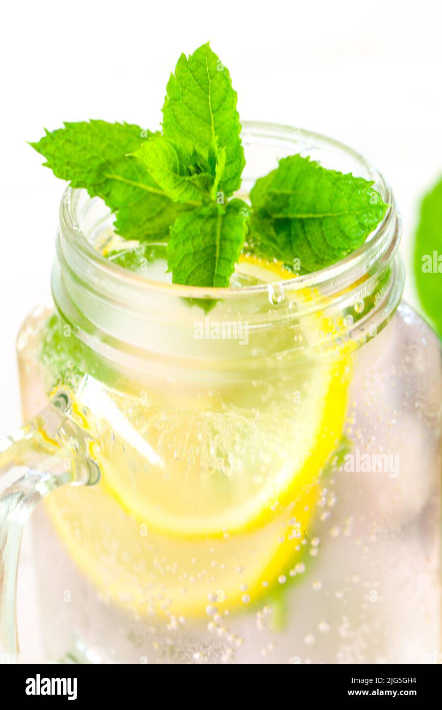 Lemon mint water with ice.Citrus cocktail with mint. Sassy lemon water.Lemon summer drink. Stock Photo