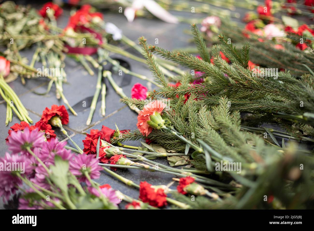 Flowers on grave of soldier in Russia. Details of funeral ceremony at