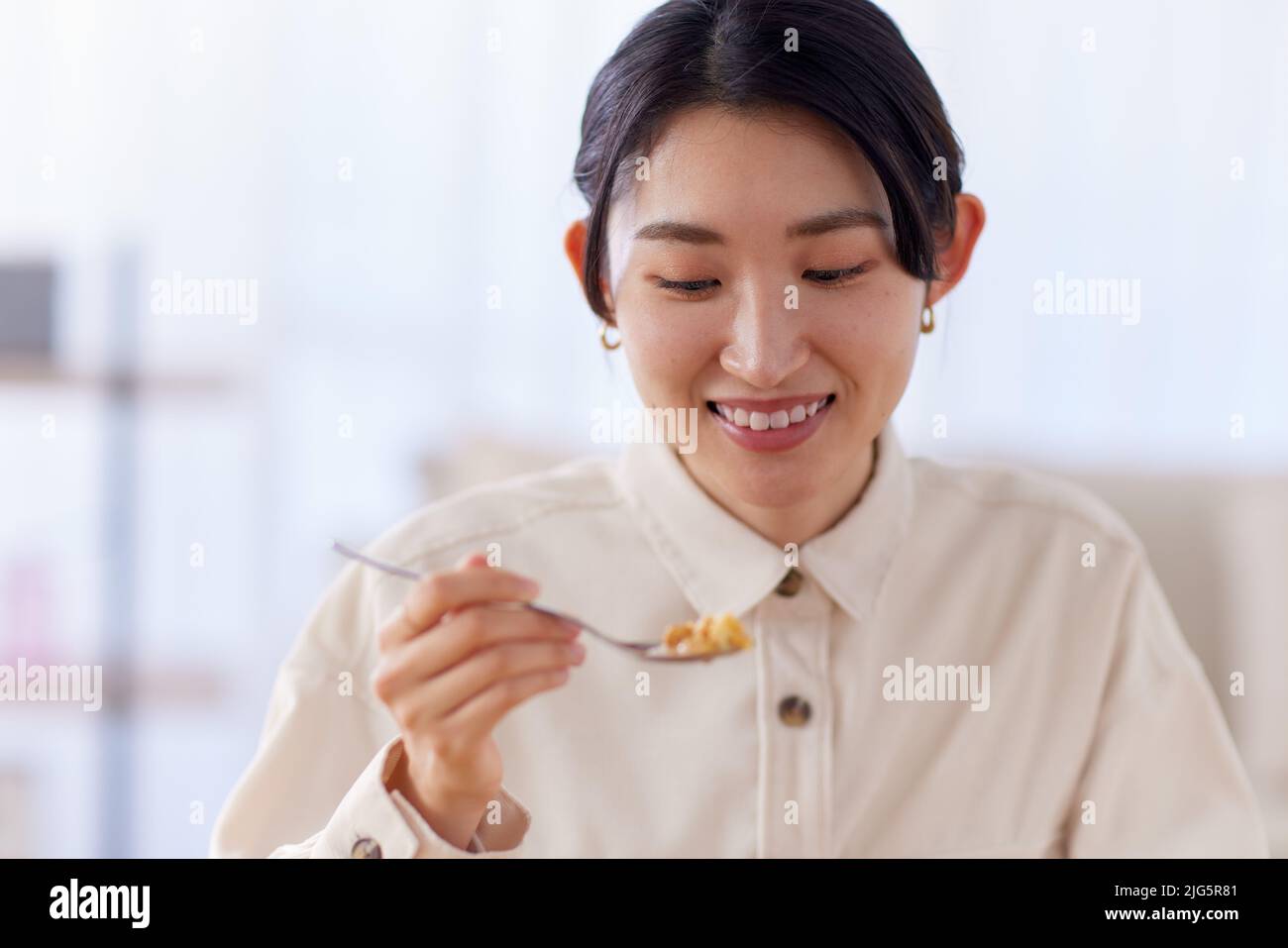 Young Japanese woman enjoying a meal Stock Photo Alamy