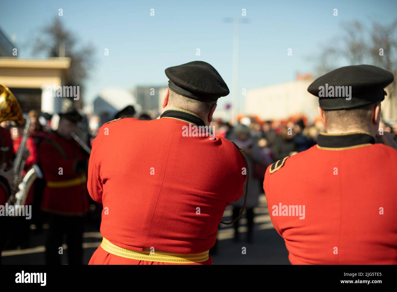 Military band in parade. Trumpeters on street. Trumpeter plays tune. Orchestra in Russia. Red ceremonial uniform. Stock Photo