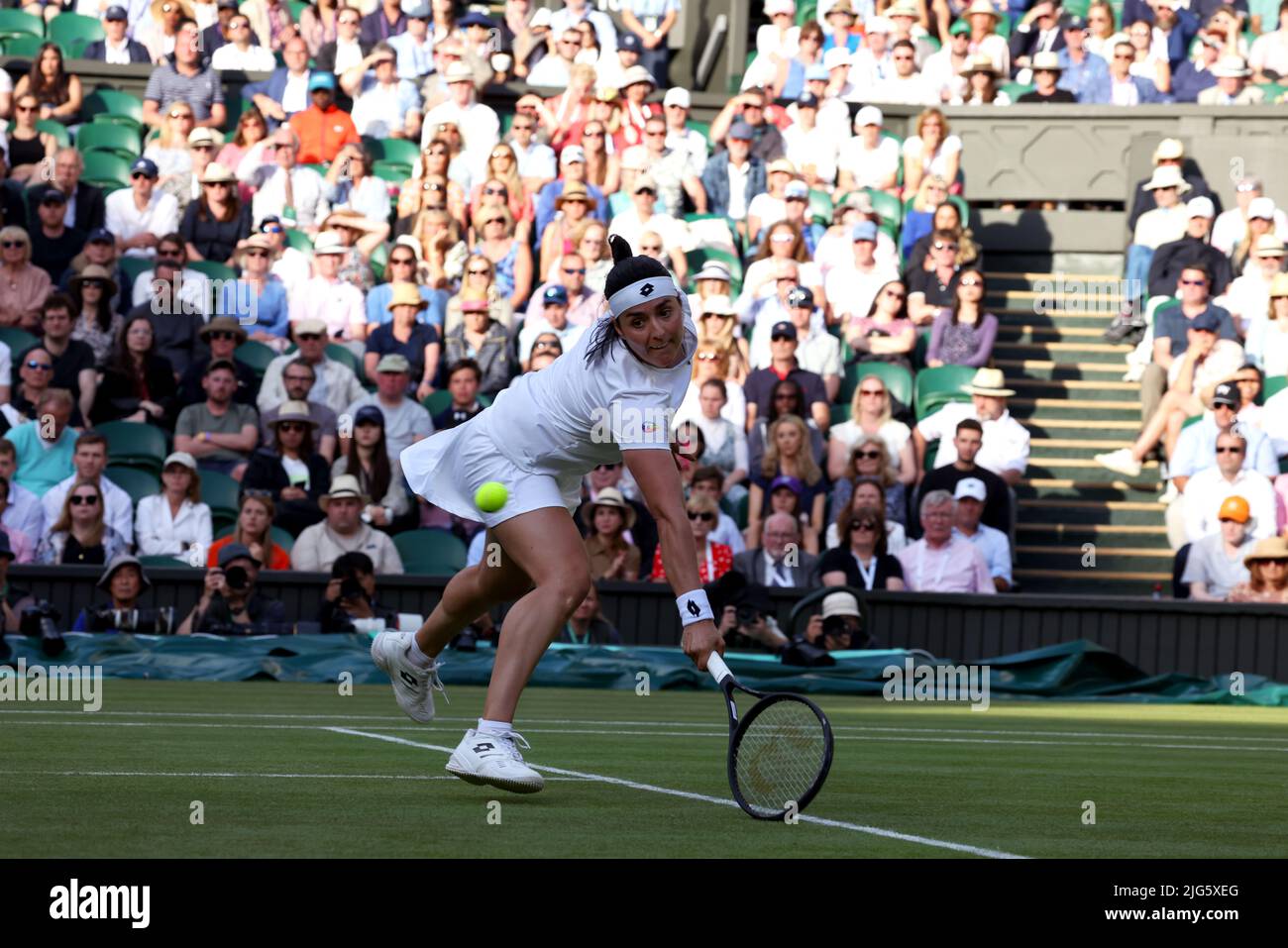 5 July 2022, All England Lawn Tennis Club, Wimbledon, London, United Kingdom:  Tunisia's Ons Jabeur scoops up a backhand half volley to Marie Bouzkova of the Czech Republic during their quarterfinal match at Wimbledon today.  Jabeur won the match to advance to the semi finals. Stock Photo