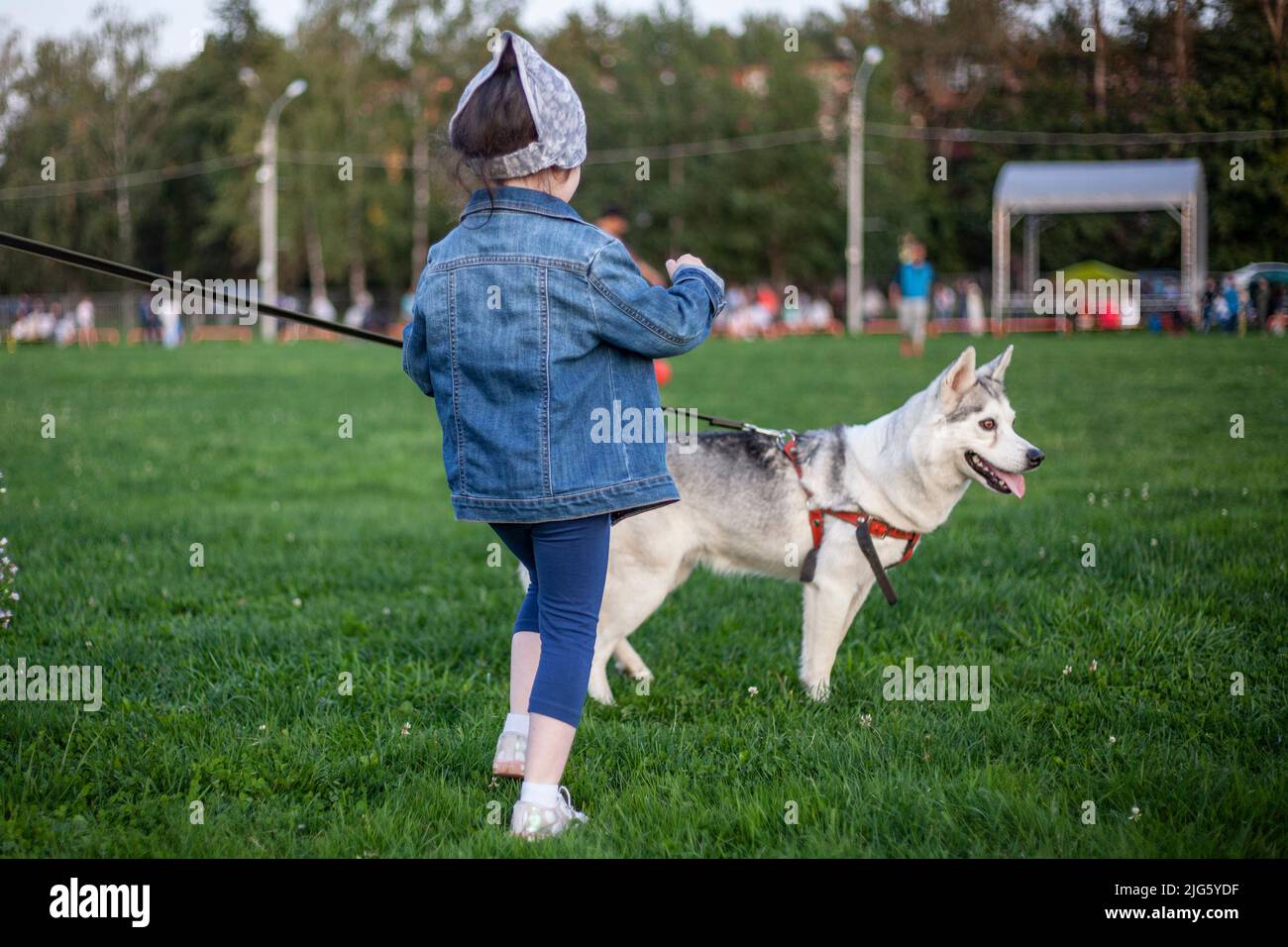 Walking the dog. The girl walks with her pet. Family vacation in the