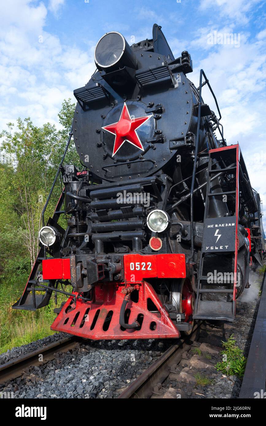The front part of the old soviet steam locomotive LV-0522 close-up on a sunny summer day. Ruskeala, Karelia Stock Photo