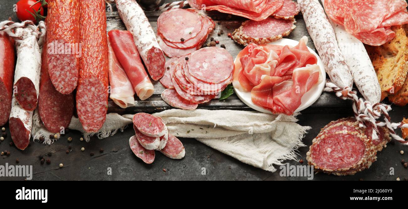 Sasusages assortment on dark background. Meat product made of finely