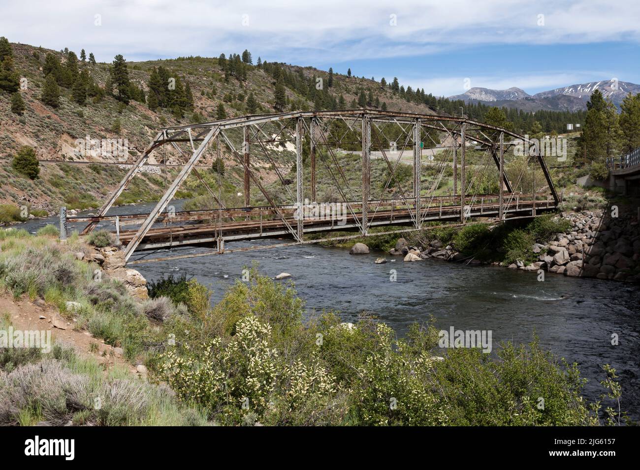 The Parker pin-connected through truss bridge with a wooden deck crosses the Truckee River at Boca, California. Stock Photo