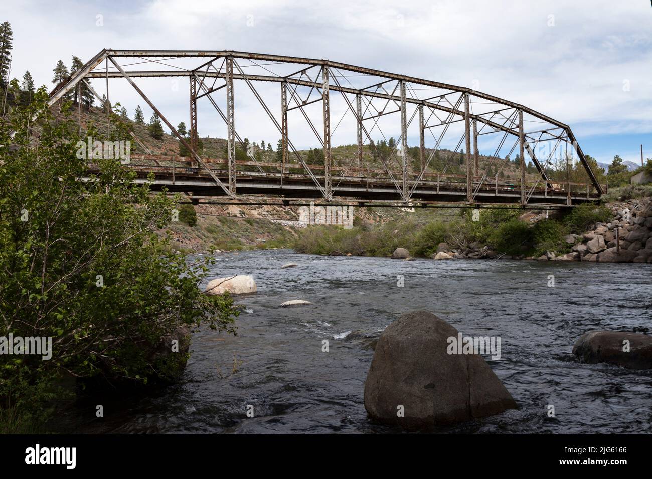 Parker pin-connected through truss bridge with a wooden deck crosses the Truckee River at Boca, California. Stock Photo