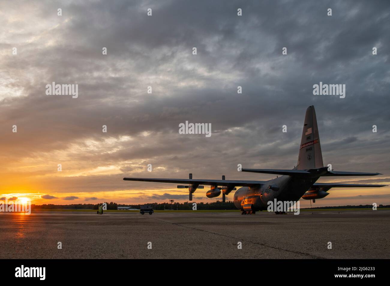 The sun sets on the final C-130H Hercules left at the 179th Airlift Wing at Mansfield Lahm ANGB, Ohio, July 6, 2022. This aircraft, tail 88-4401, will retire and become a static display at the MAPS Air Museum (Military Aviation Preservation Society), an internationally known museum of aviation in North Canton, Ohio. After being selected to become the nation's first Air National Guard Cyber Wing, the unit is transitioning from flying the C-130H Hercules to a new mission assigned to Air Combat Command. (U.S. Air National Guard photo by Master Sgt. Joe Harwood) Stock Photo