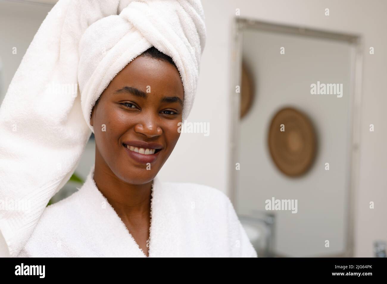 Portrait of beautiful young African American woman in underwear lying  relaxing on white bed at home. Smiling pretty millennial black female in  underclothing garment. Body positive concept. Stock-foto