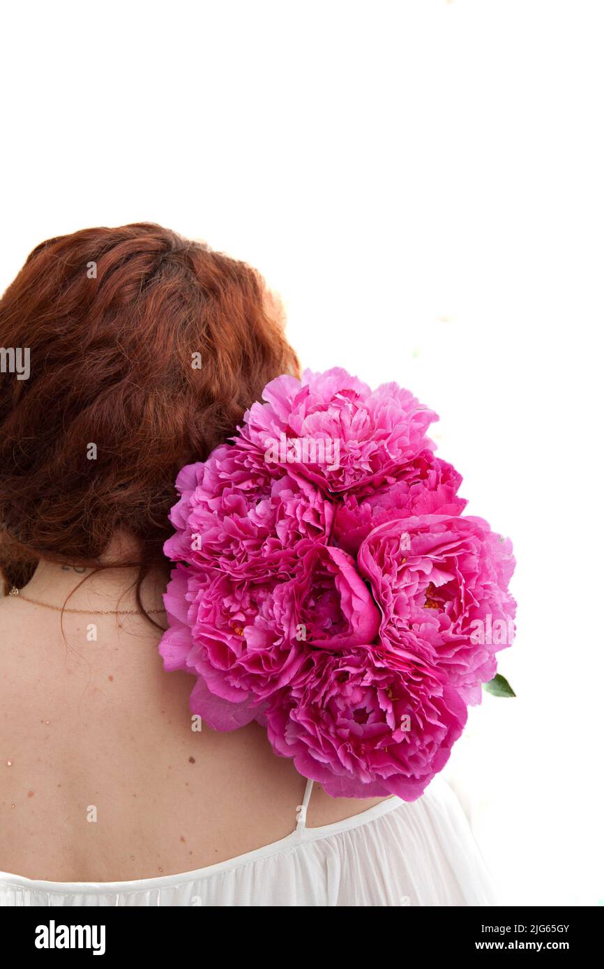 Cut out of a woman holding a beautiful bouquet of pink peonies for wedding celebration Stock Photo