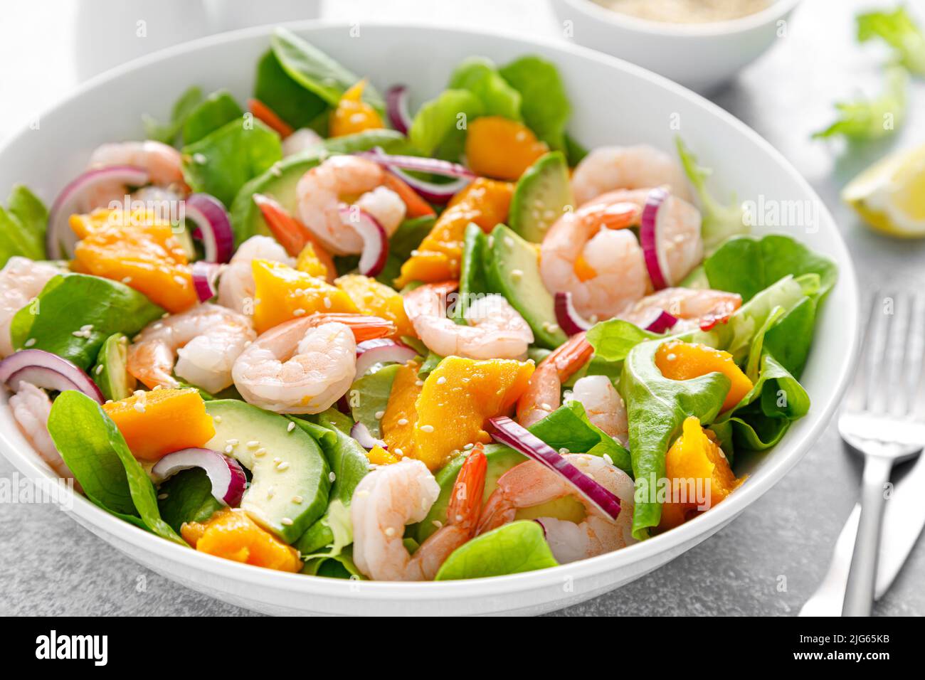 Shrimp, avocado and mango salad with fresh green lettuce. Prawn salad Stock Photo