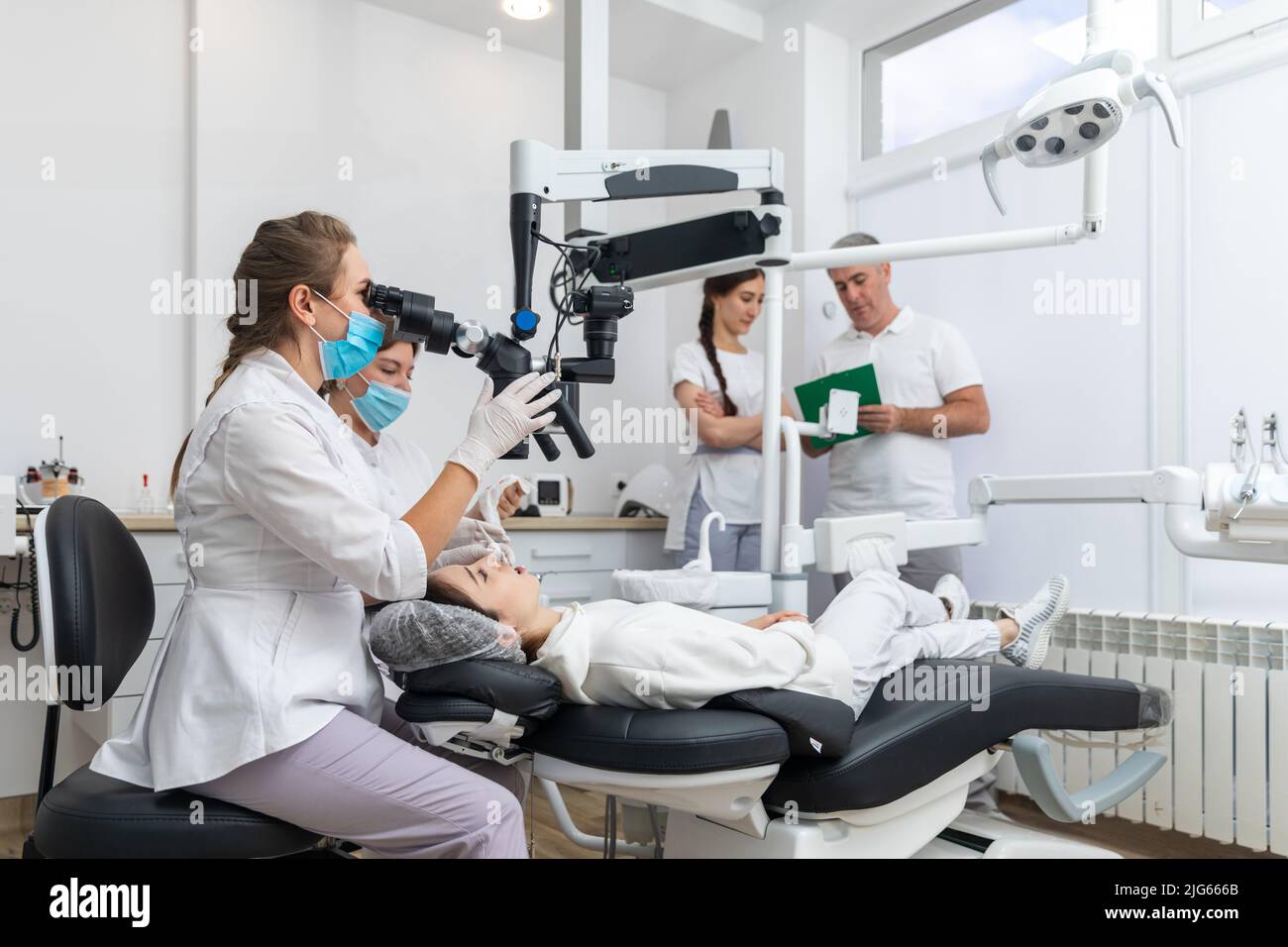 Group of young doctors learning in dental clinic watching dental